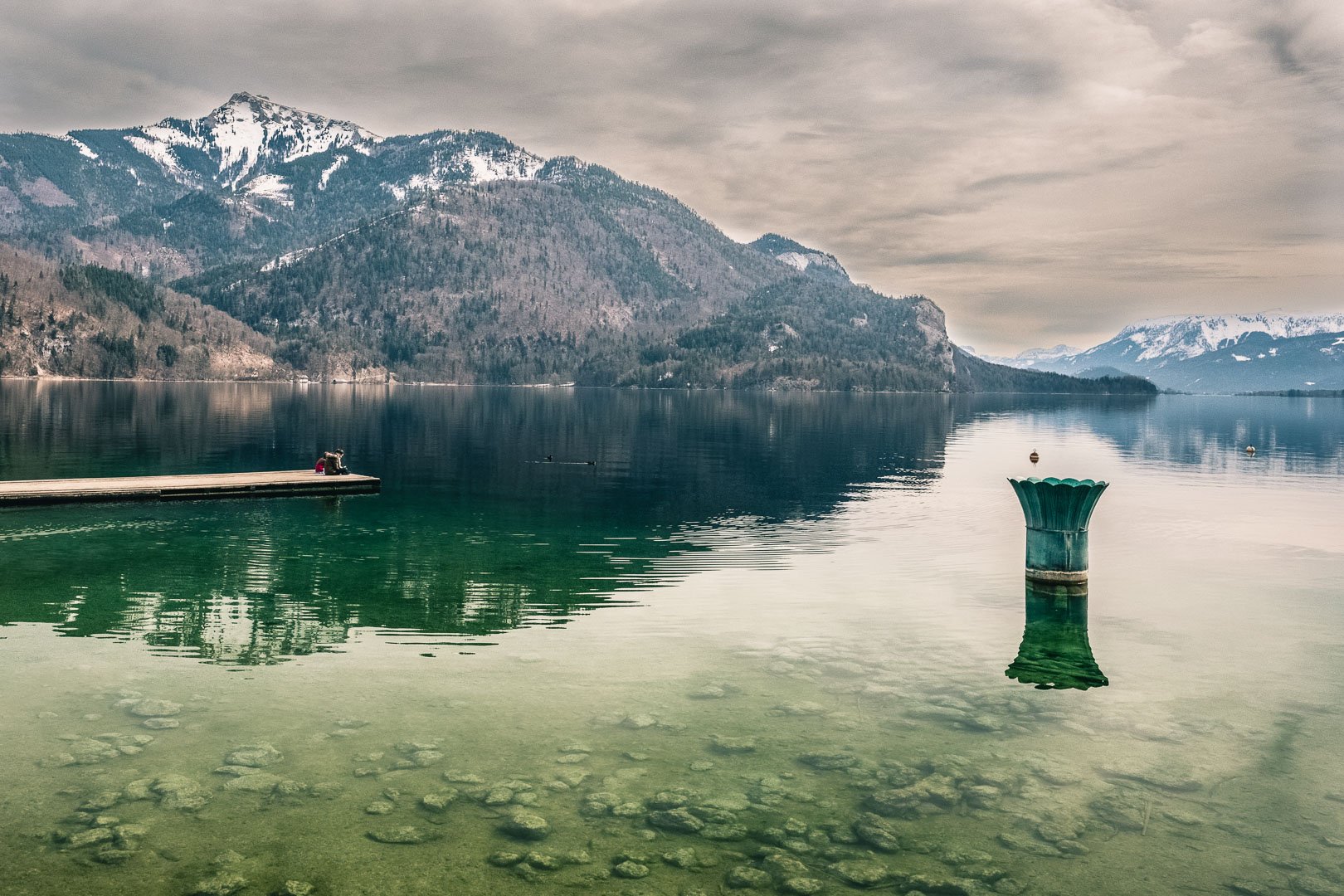 St Gilgen am Wolfgangsee Two Children sitting in the dock of the bay in Sankt Gilgen